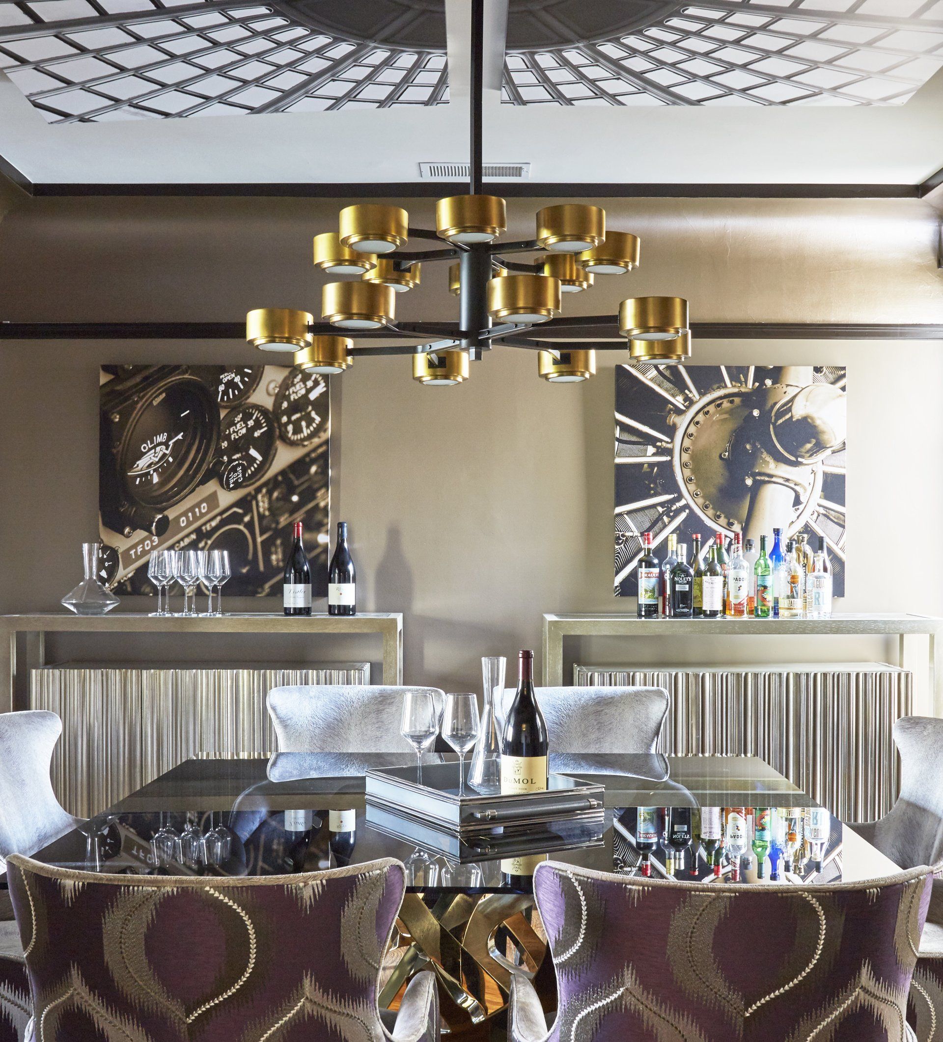 A dining room with a table and chairs and a chandelier