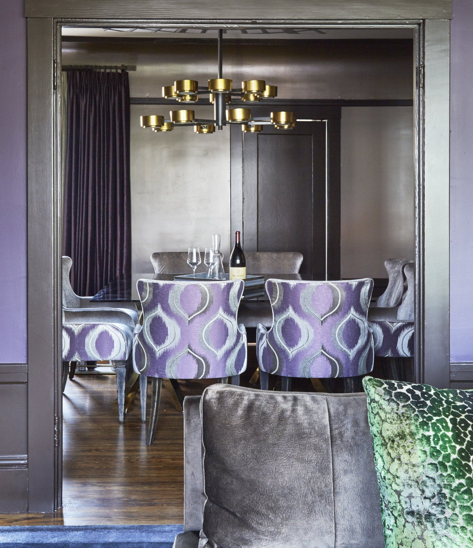 A dining room with purple chairs and a table