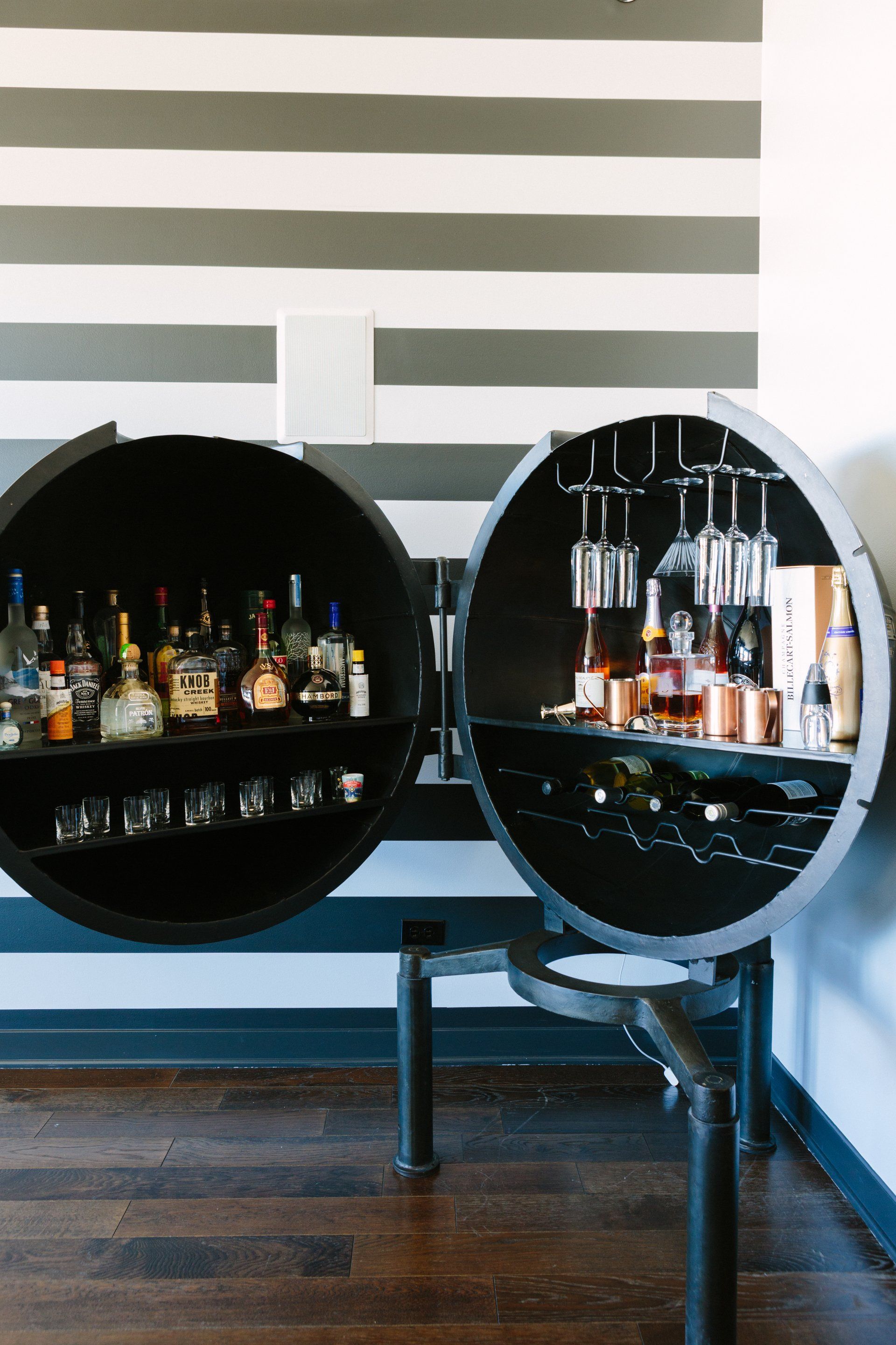 A bar filled with bottles of liquor and wine glasses.