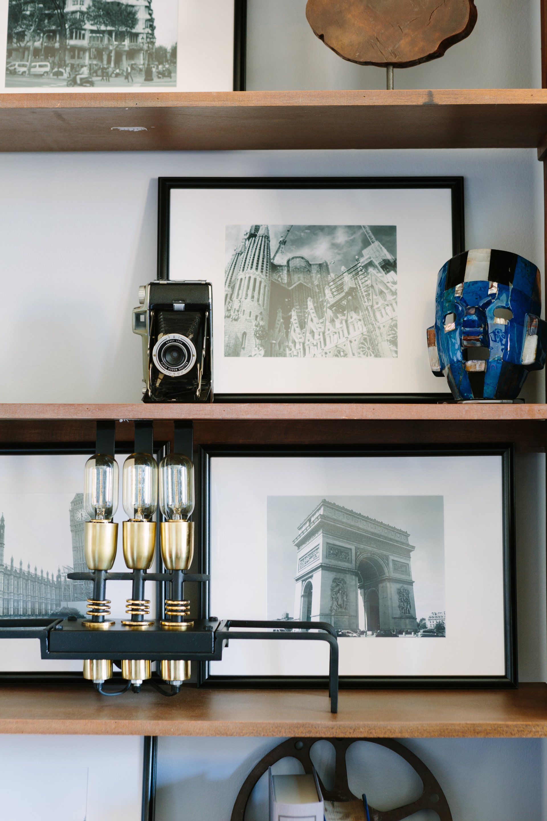 A shelf with pictures and a clock on it
