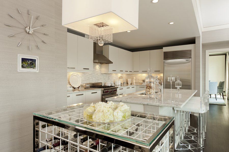 A kitchen with a wine rack and a clock on the wall.