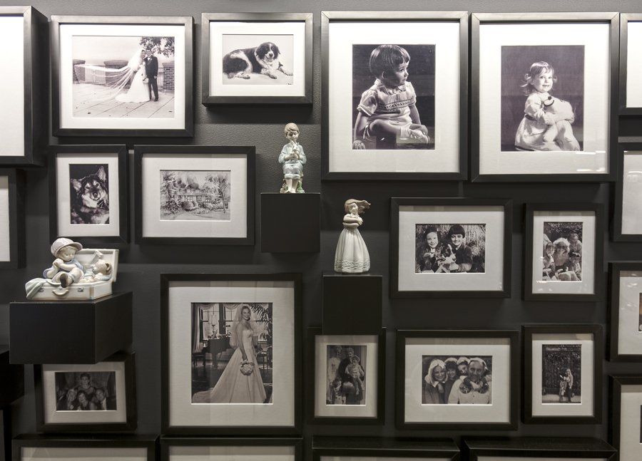 A wall with a lot of framed pictures on it