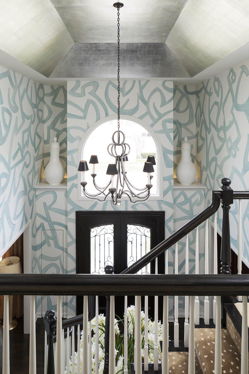 A staircase with a chandelier hanging from the ceiling