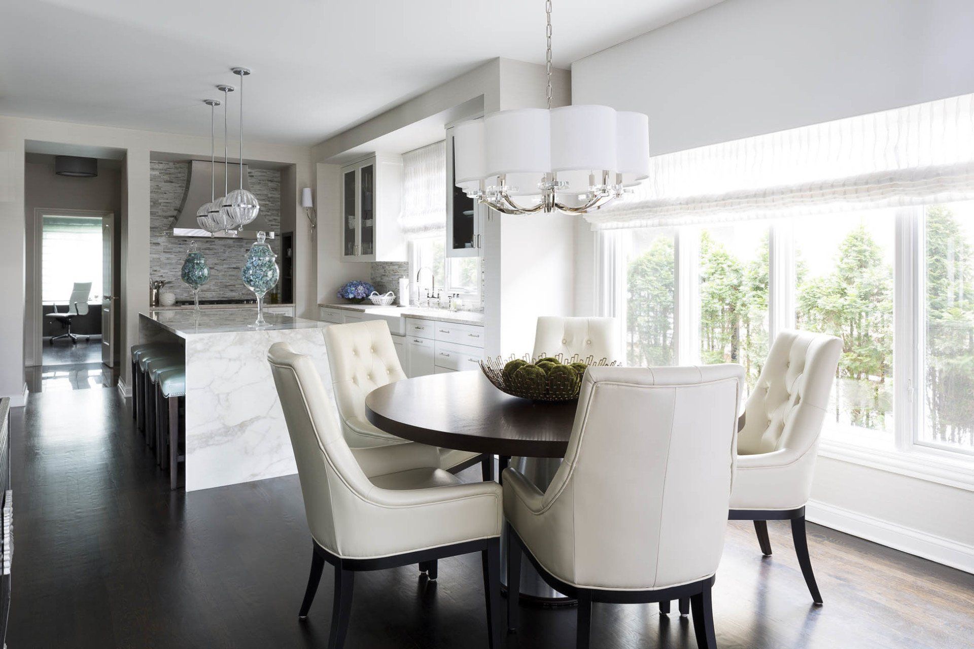 A dining room with a table and chairs and a chandelier.