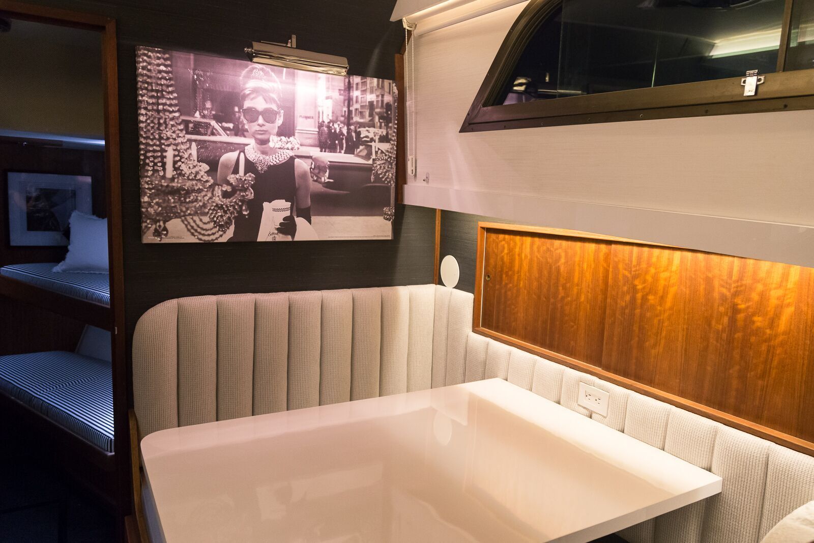 A room with a table and a picture on the wall.