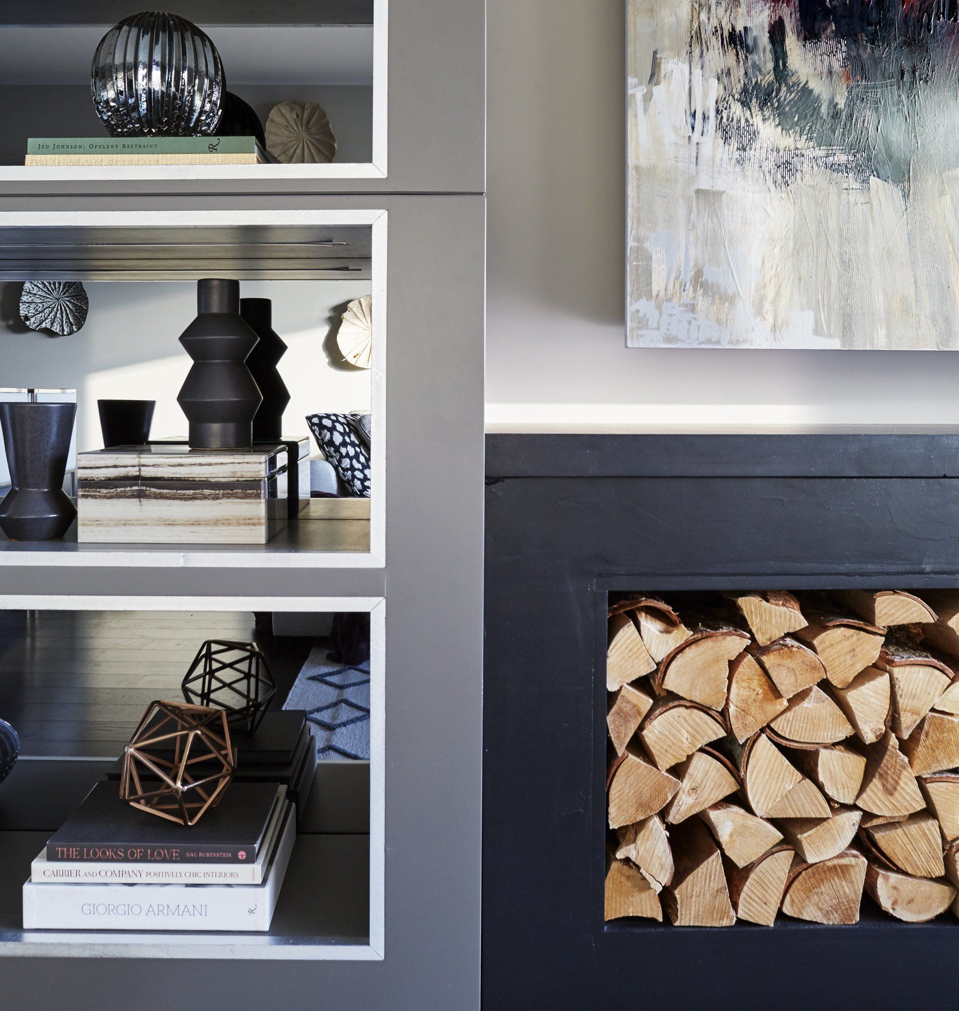 A living room with a fireplace filled with logs