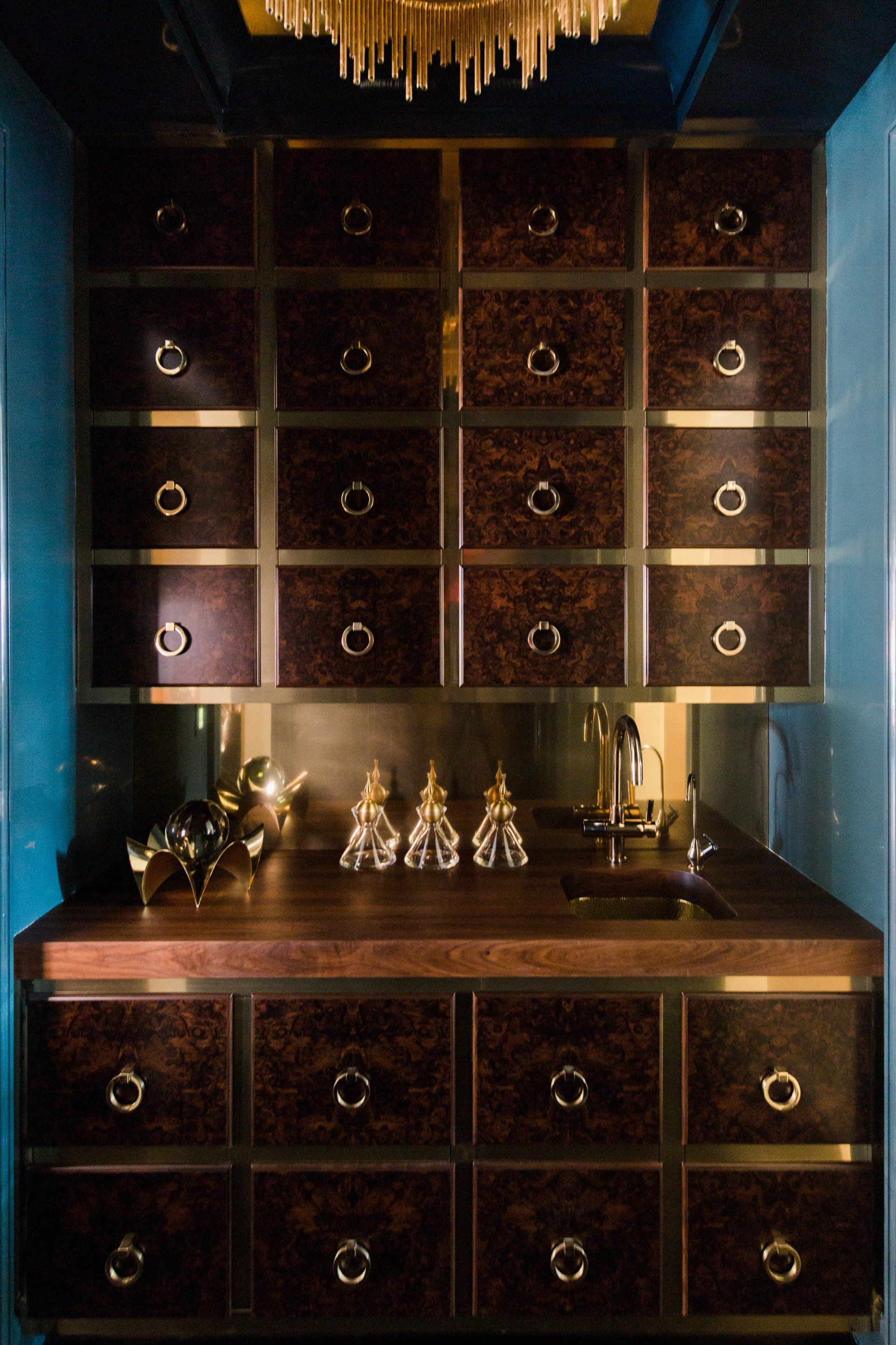 A kitchen with lots of drawers and a sink