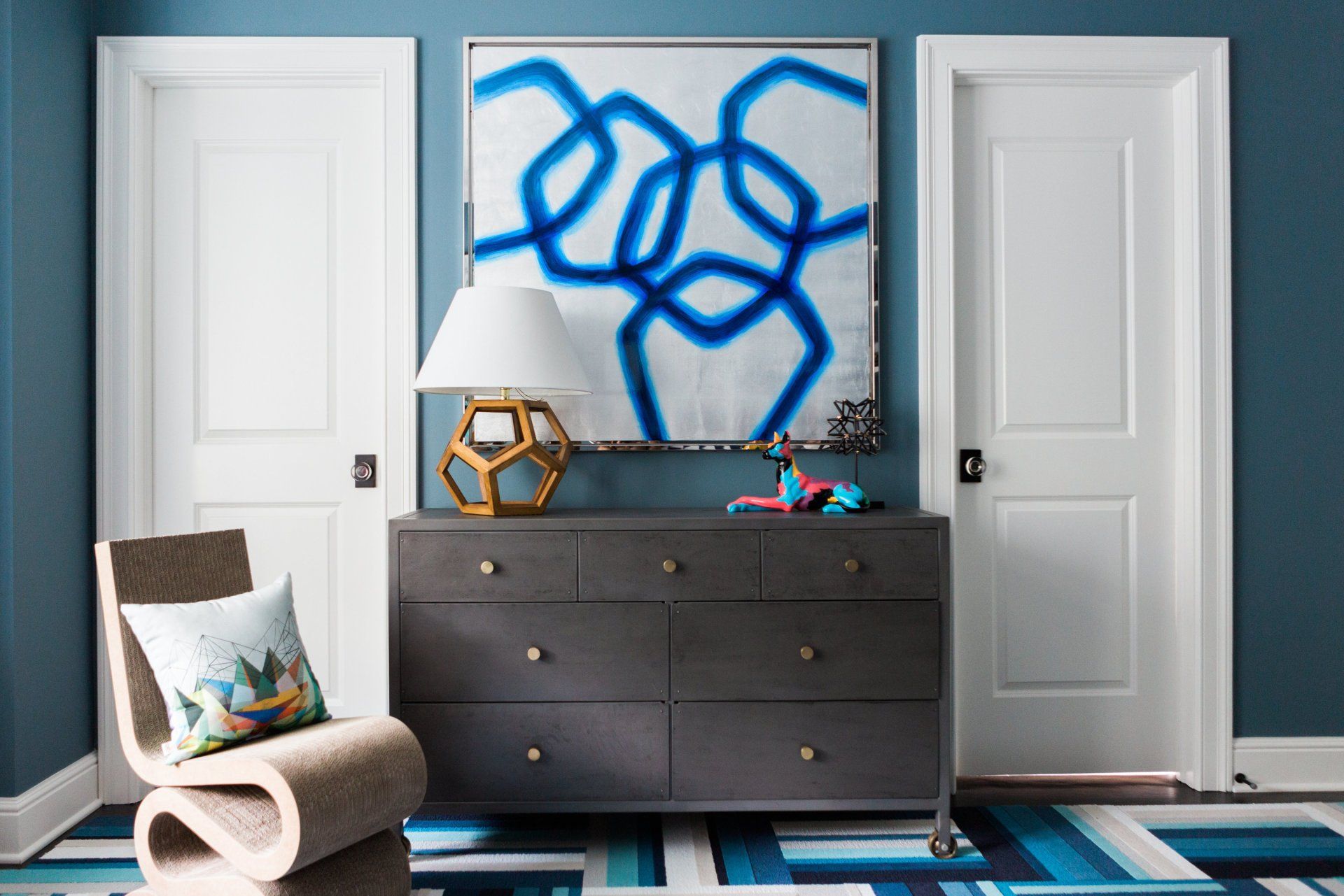 There is a painting on the wall above the dresser in the room.