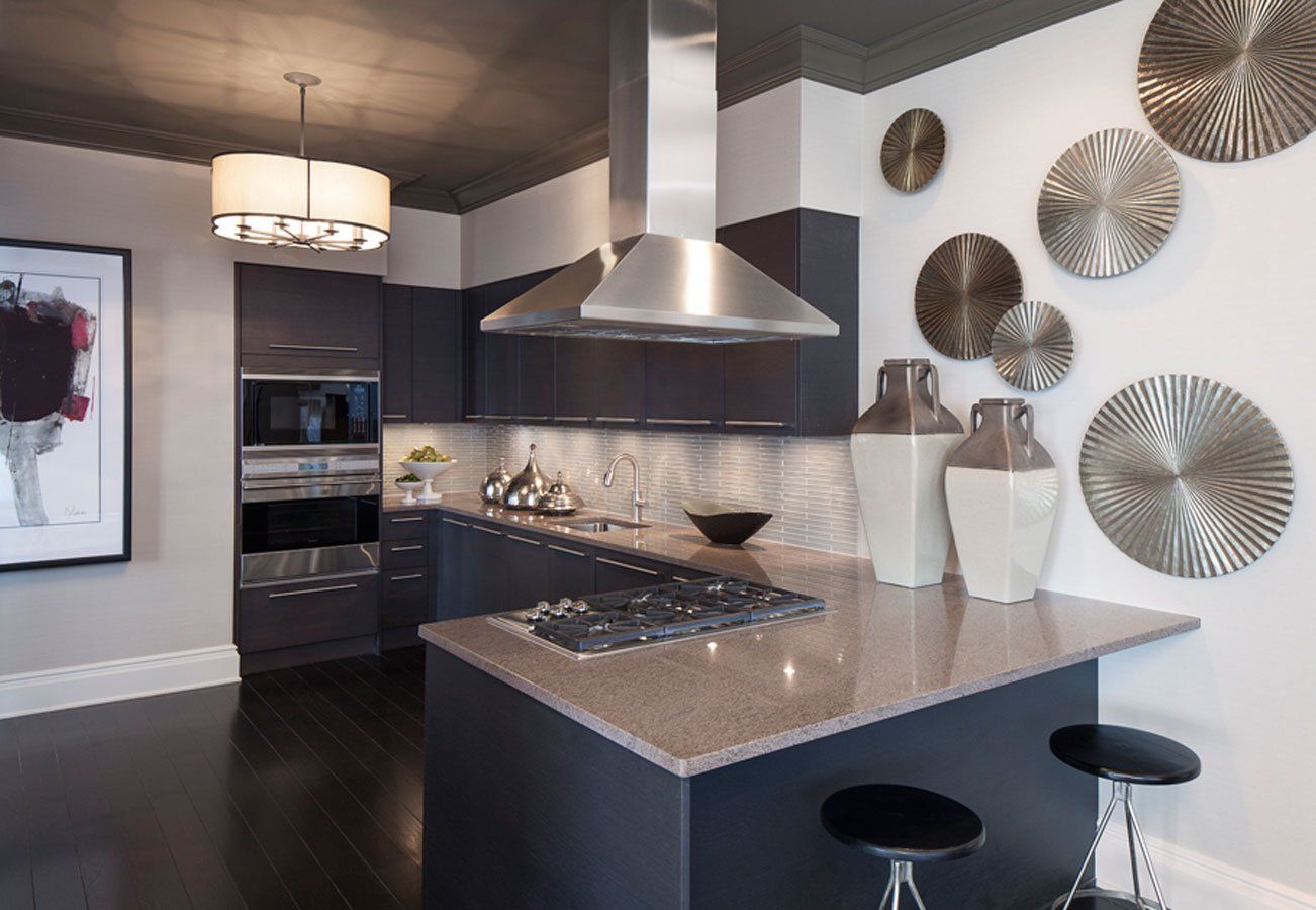 A kitchen with stainless steel appliances and a large island