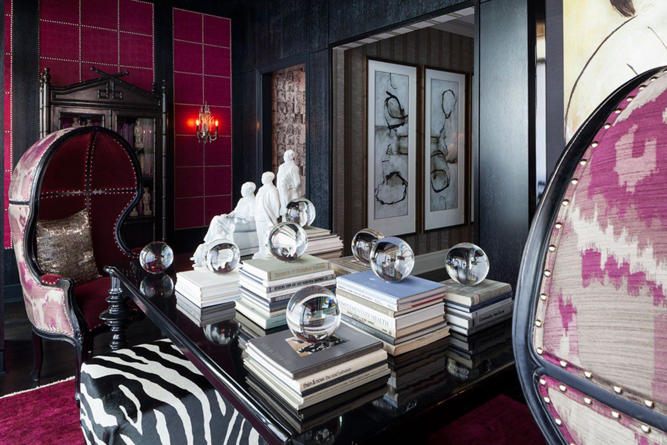 A room with a zebra print chair and a table with books on it