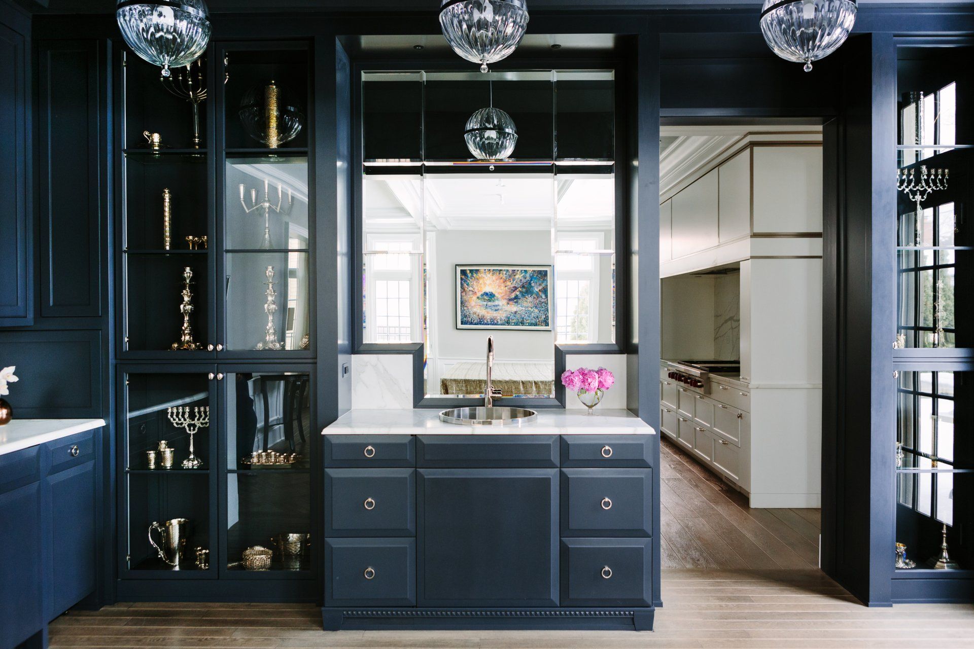 A kitchen with dark blue cabinets and white counter tops
