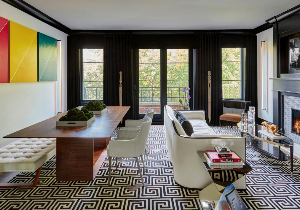 A living room with a table and chairs and a fireplace