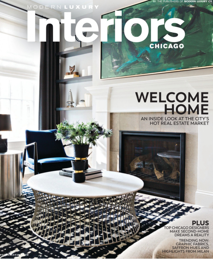 A living room with a fireplace and a coffee table on the cover of a magazine.