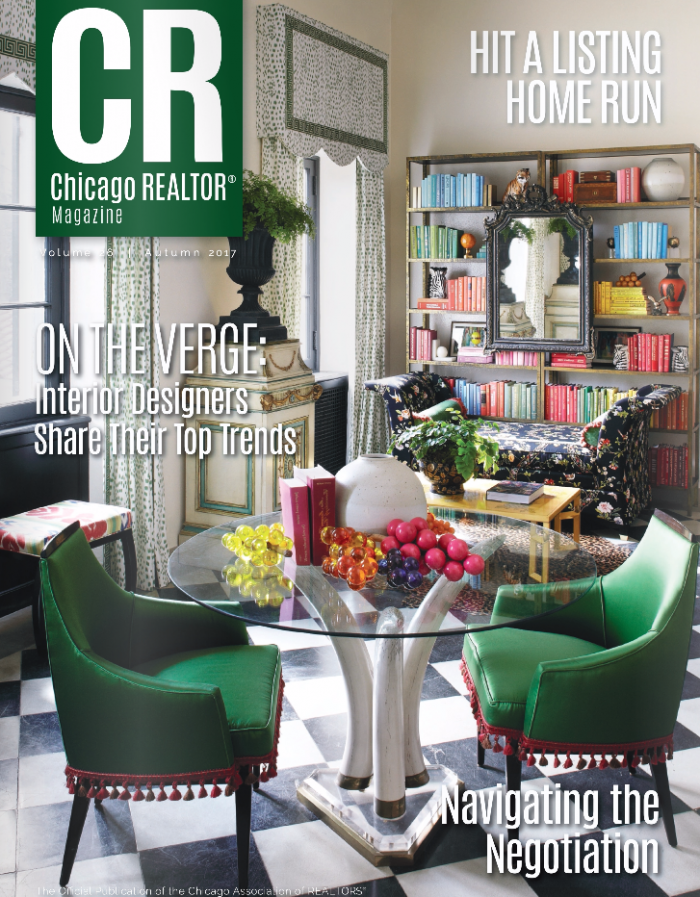 The cover of the chicago realtor magazine shows a living room with green chairs and a glass table.