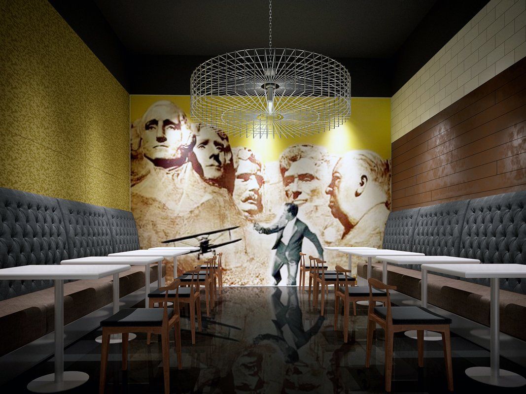 A man in a suit is standing in a room with tables and chairs