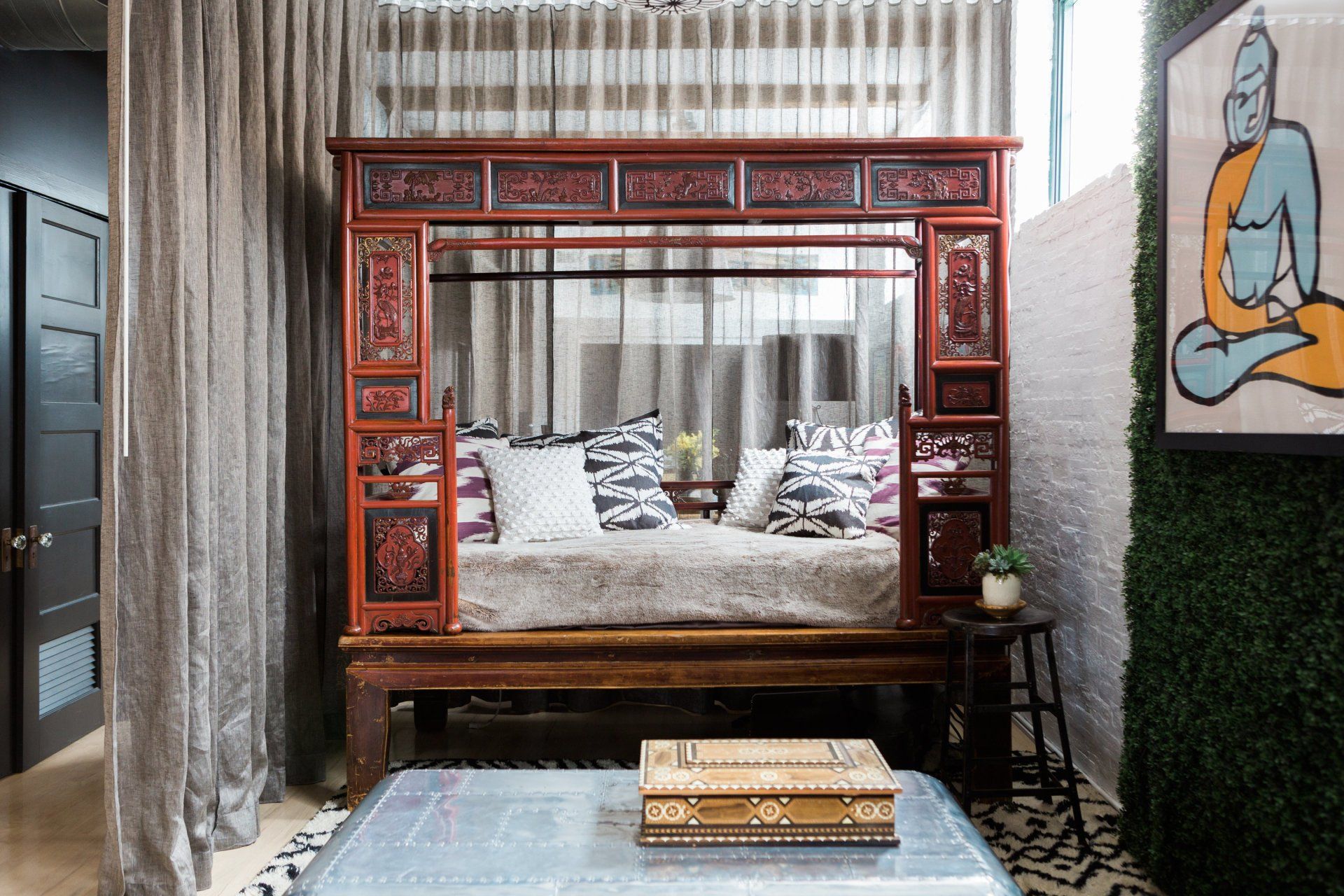 A living room with a canopy bed and a coffee table.