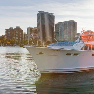 A large white boat is floating on top of a body of water.