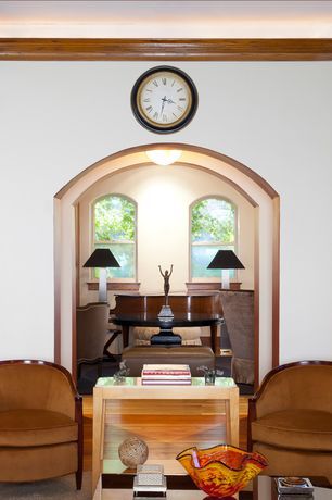 A living room with two chairs and a clock on the wall