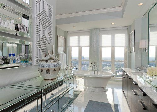 A bathroom with a tub , sinks , mirrors and a large window.