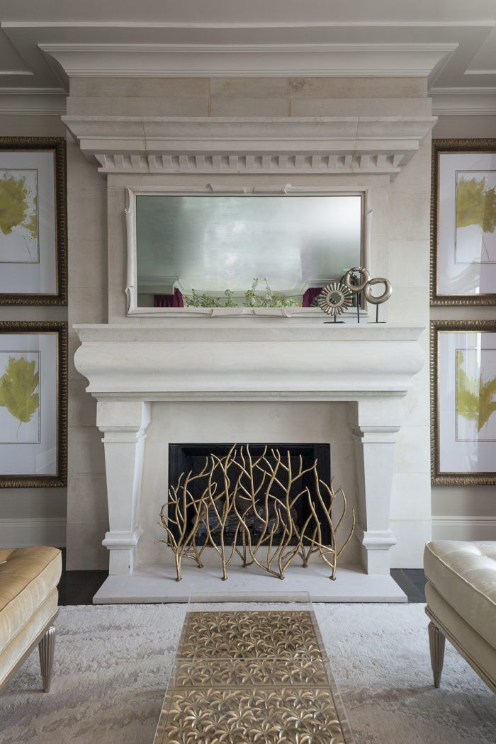 A living room with a fireplace and a mirror