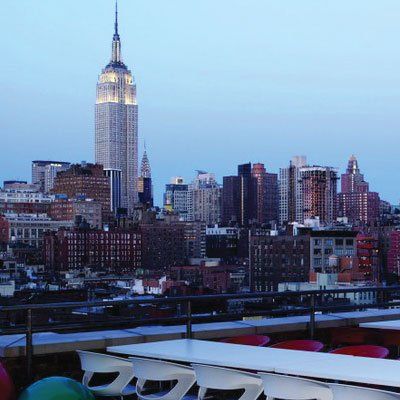 The empire state building is lit up in the distance