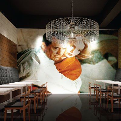 A dining room with tables and chairs and a large painting of a man and woman hugging