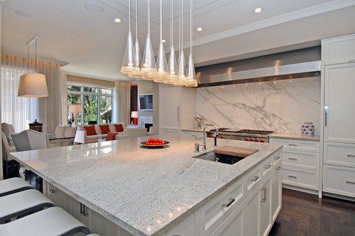 A kitchen with white cabinets and granite counter tops