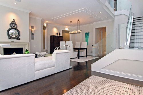 A living room with white furniture and a fireplace