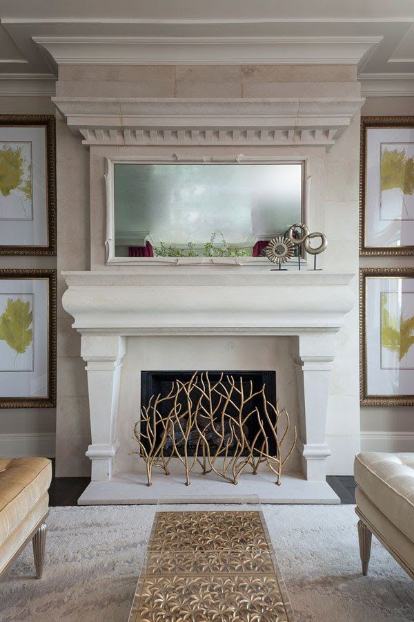 A living room with a fireplace and a mirror above it