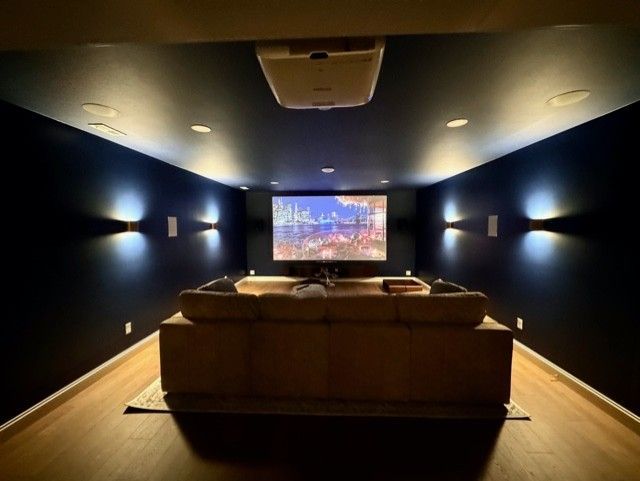 A home theater with a projector and a couch