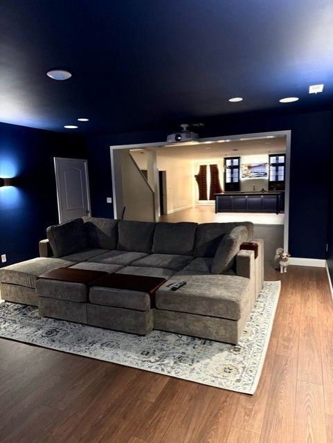 A living room with a sectional couch and a rug