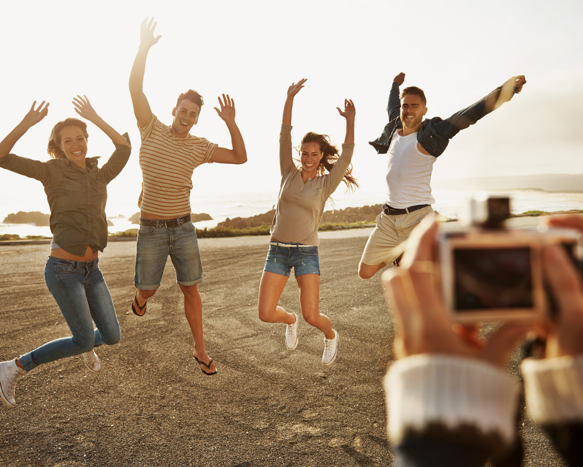 A group of people are standing next to each other and laughing.