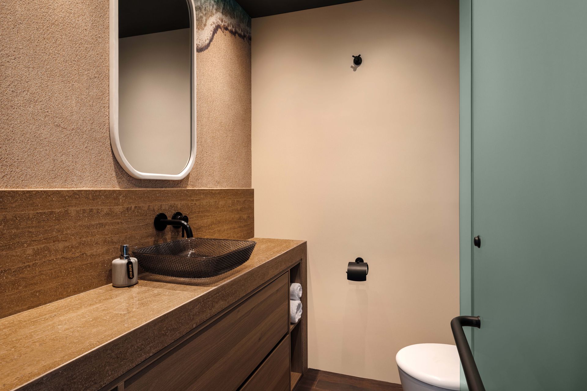 A bathroom with a sink , toilet and mirror.