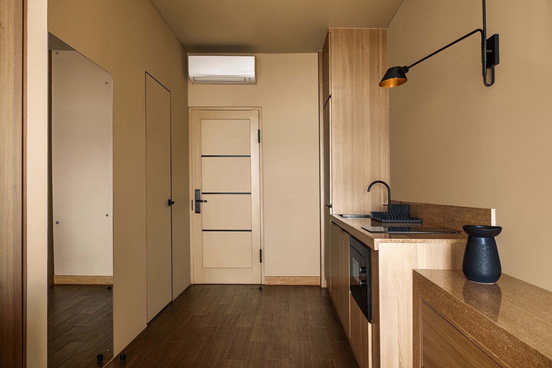 A kitchen with wooden cabinets , a sink , and a refrigerator.