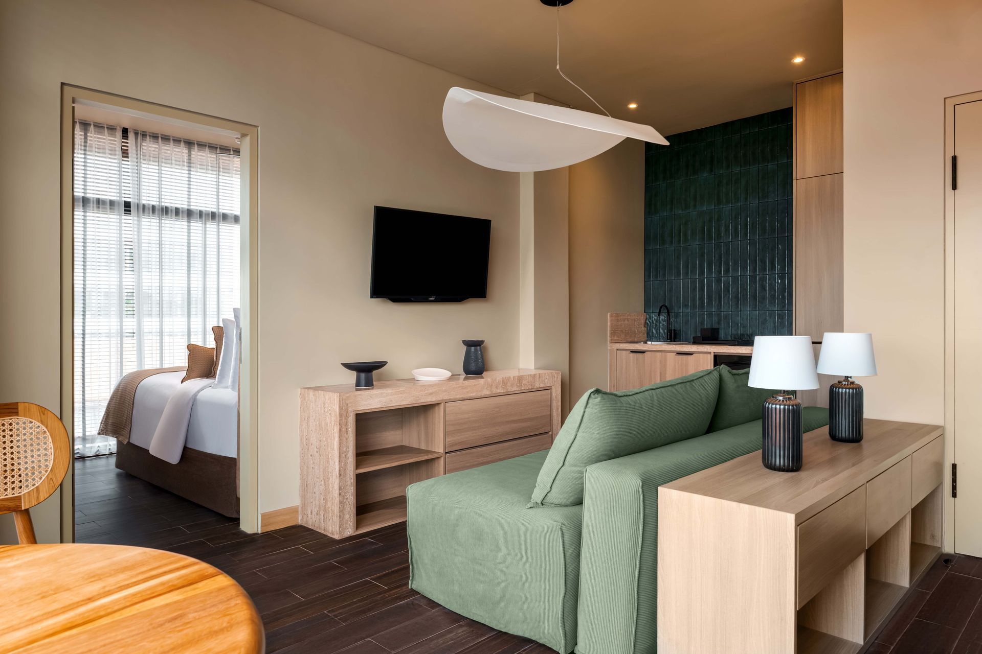 A hotel room with a couch , table , and television.