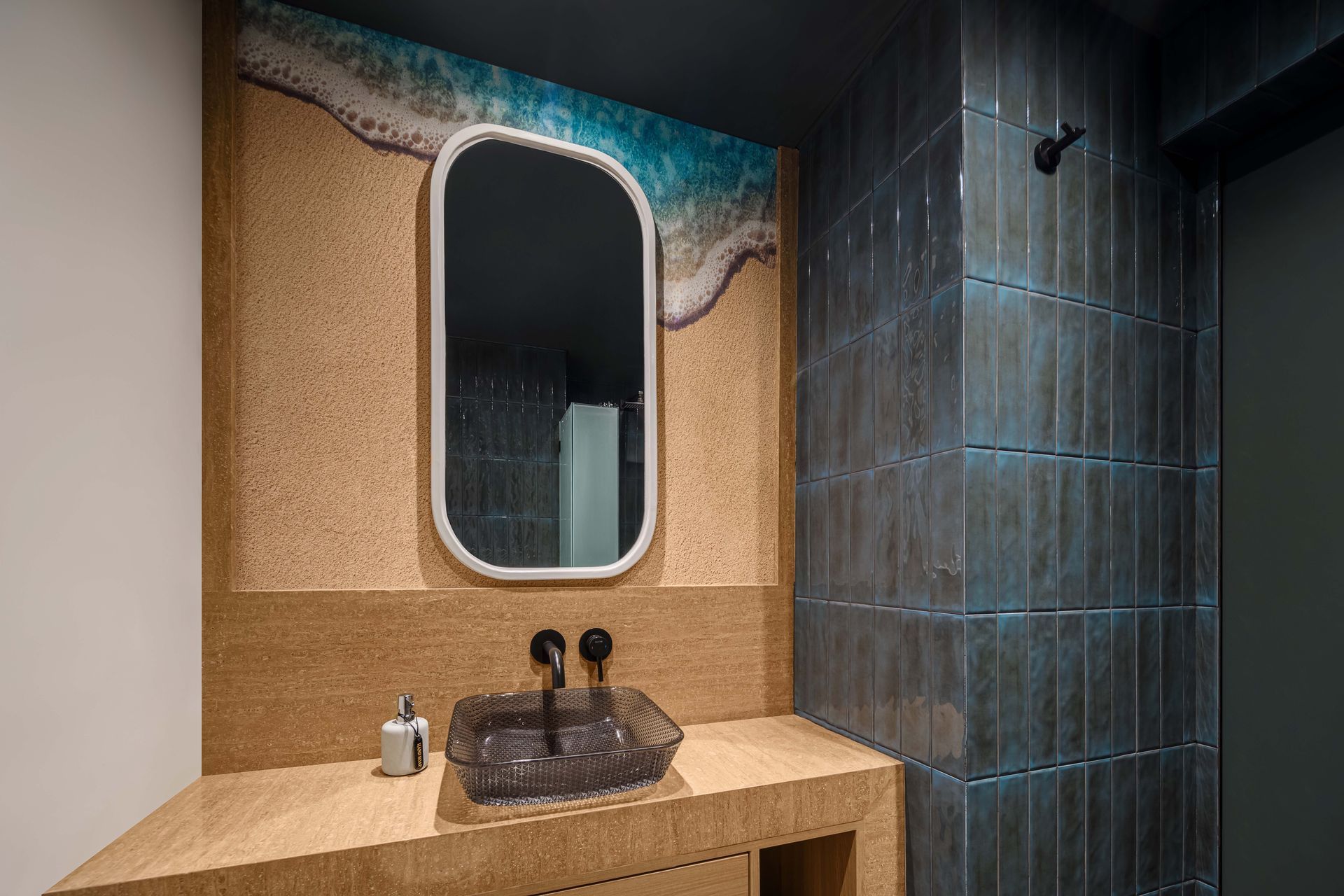 A bathroom with a sink , mirror and shower.