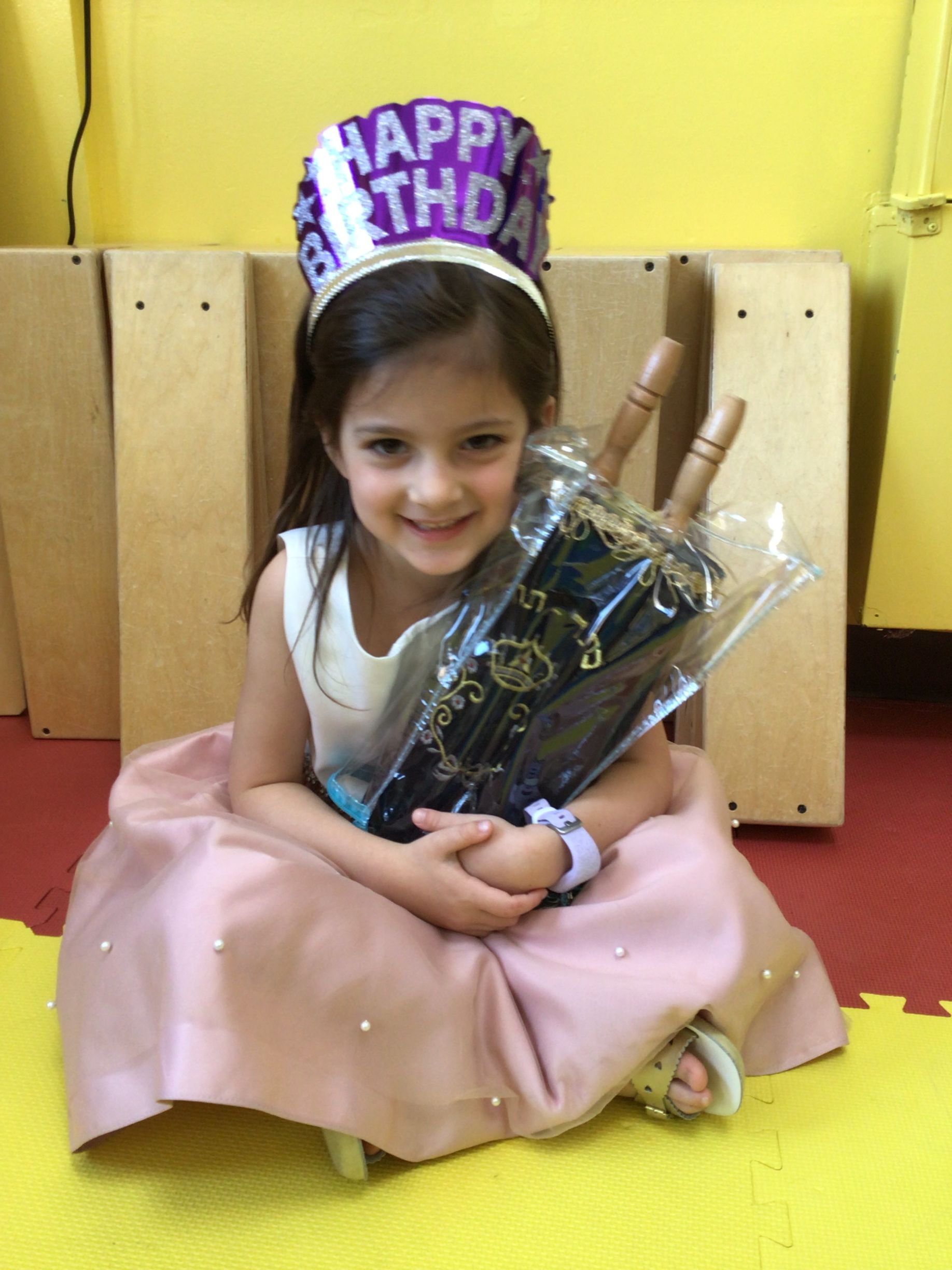 young girl holding The Torah