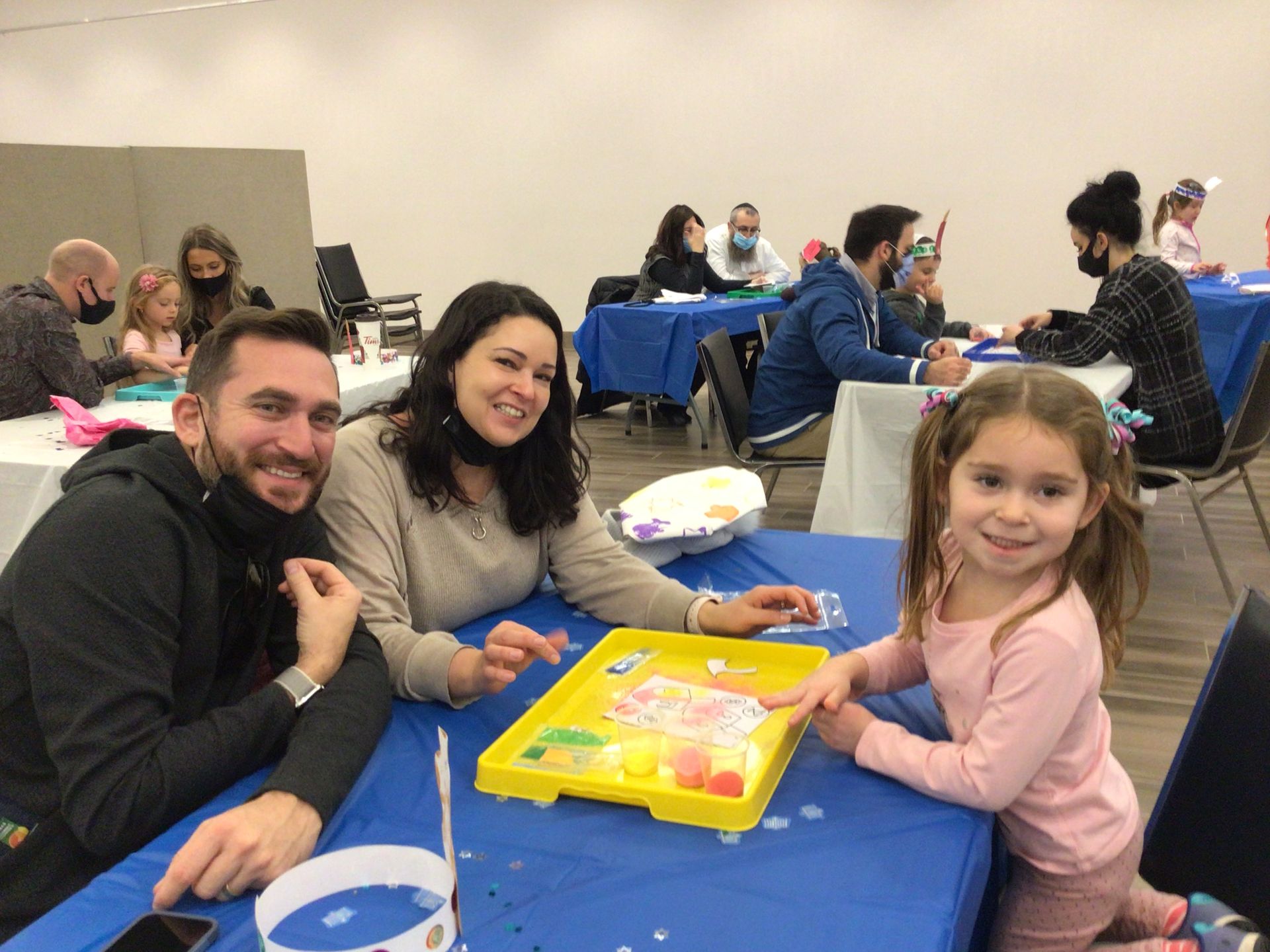 A group of people are sitting at tables playing a game.
