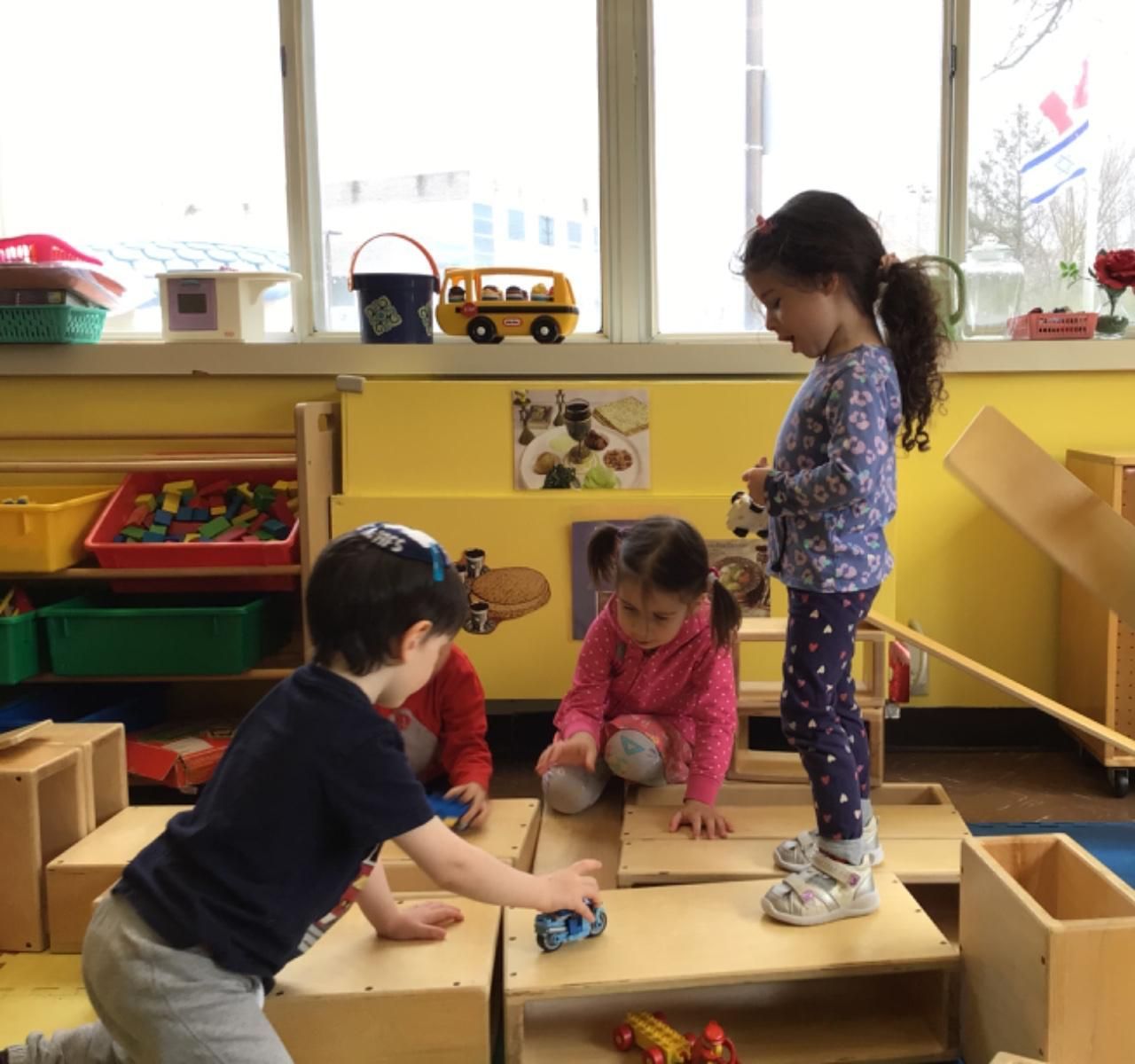 A group of children are playing with toys in a room
