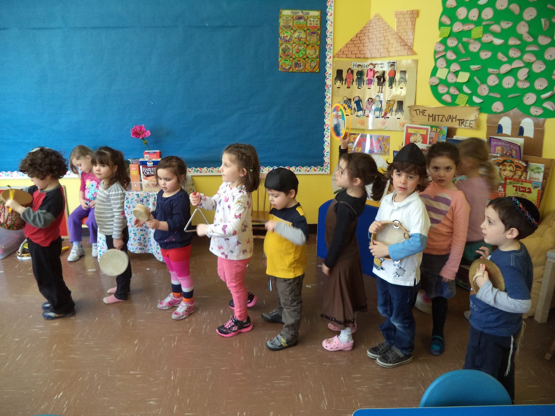 A group of children are playing instruments in a classroom