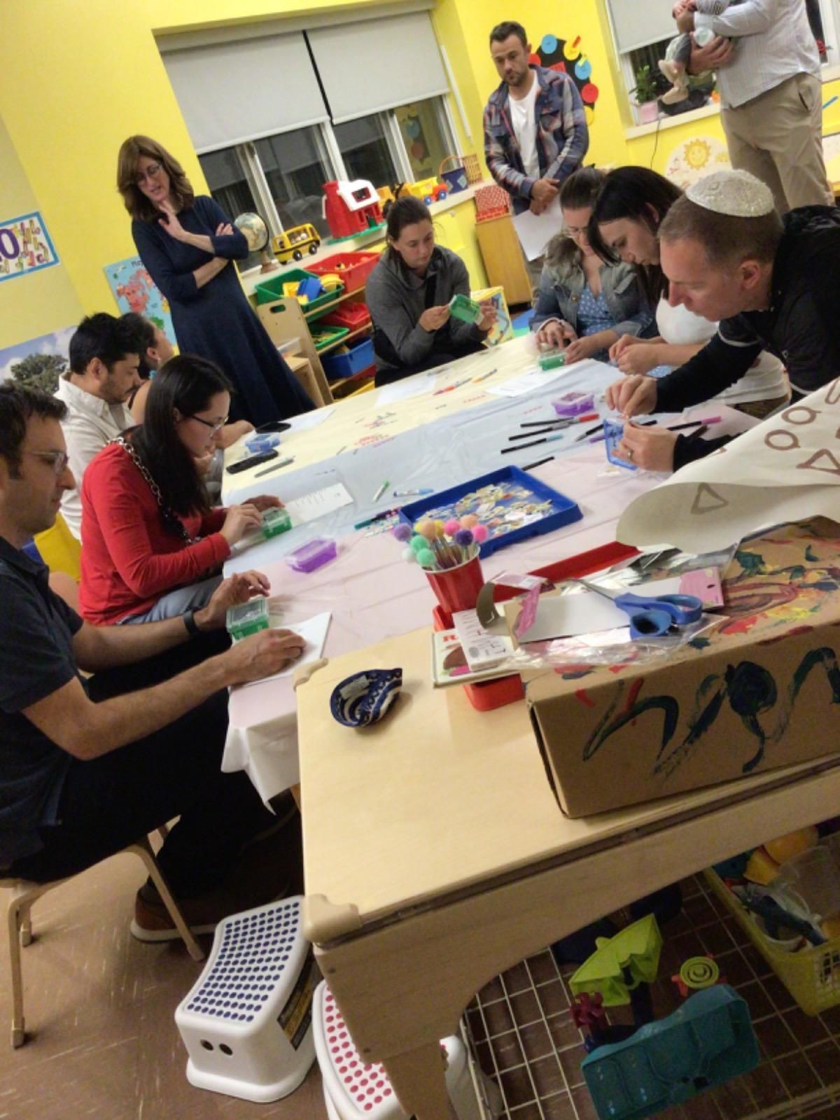 A group of people are sitting around a table in a room