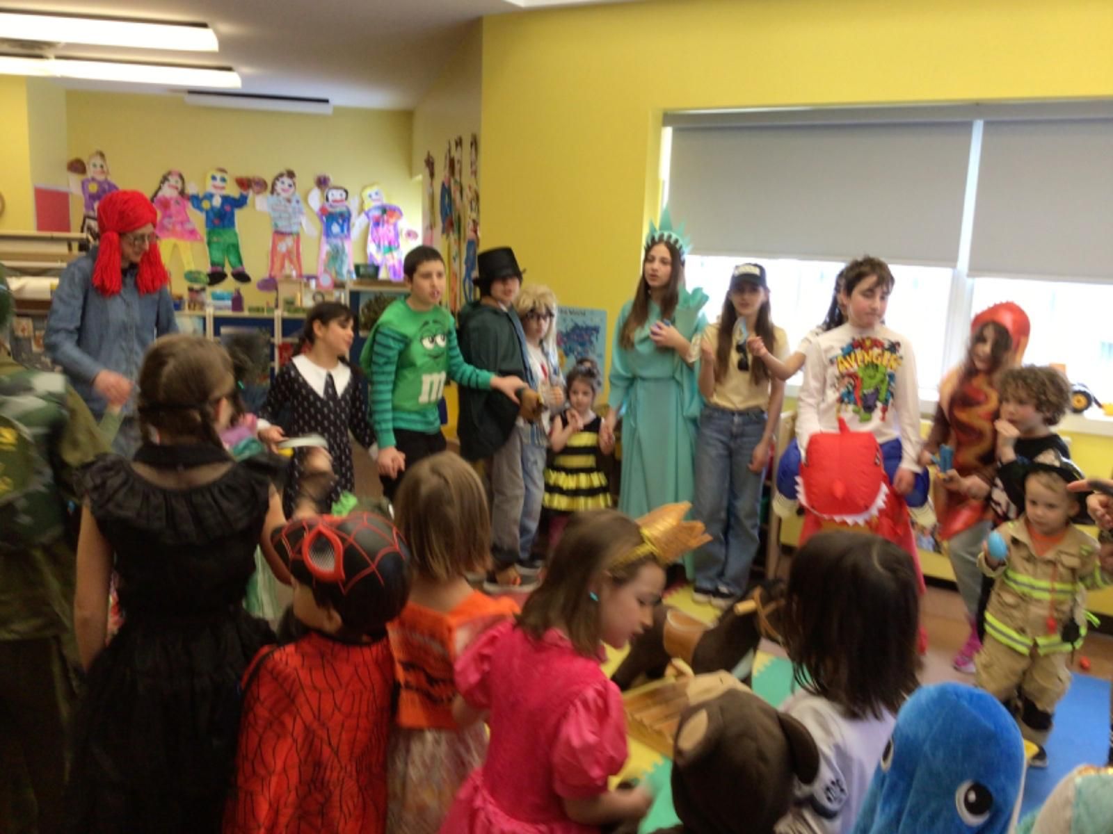 A group of children dressed in costumes are standing in a room