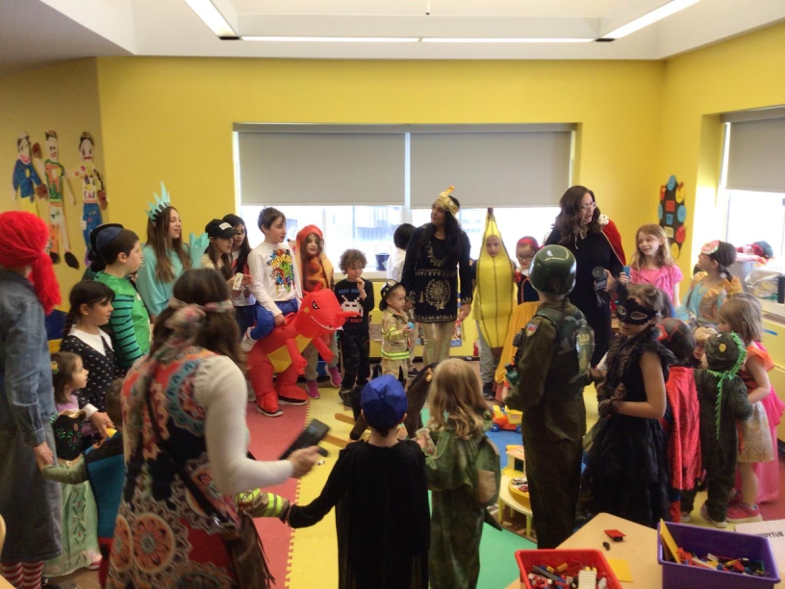 A group of children dressed in costumes are dancing in a room