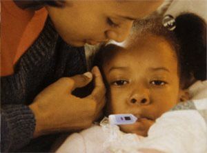 Mother taking the temperature of her sick child