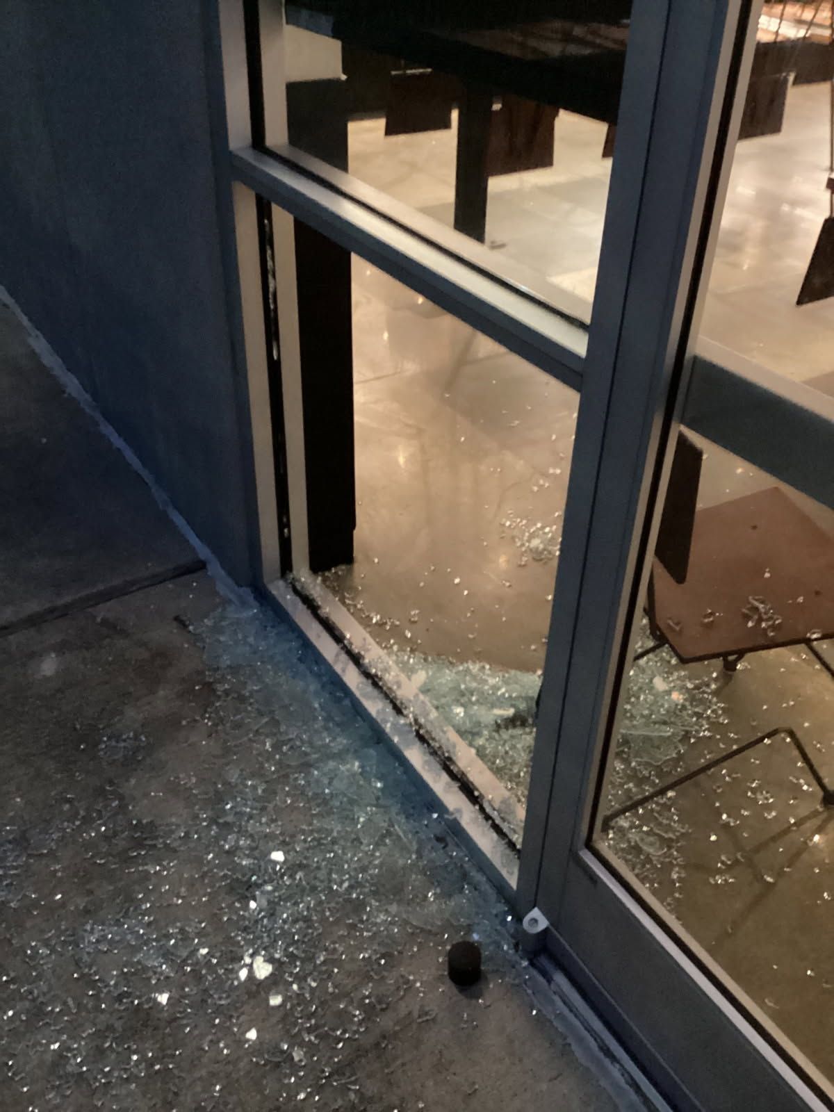 A broken glass door is sitting on the sidewalk