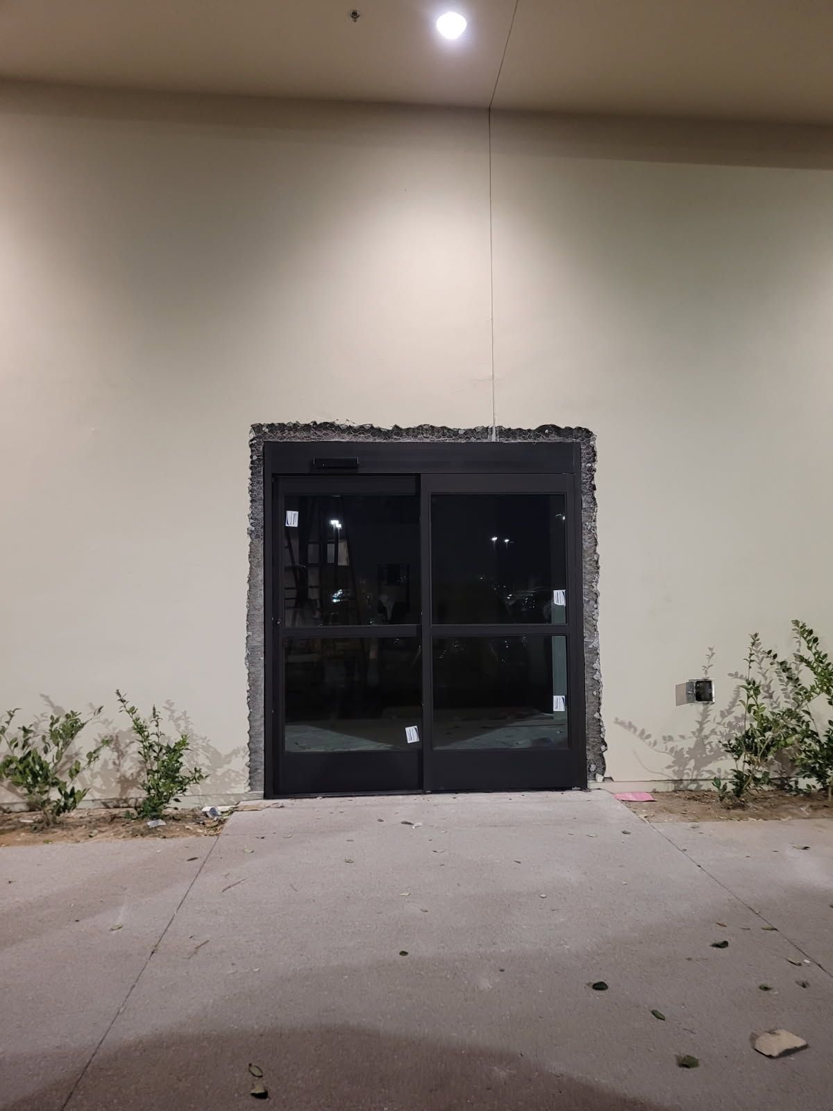 A sliding glass door with a white wall behind it