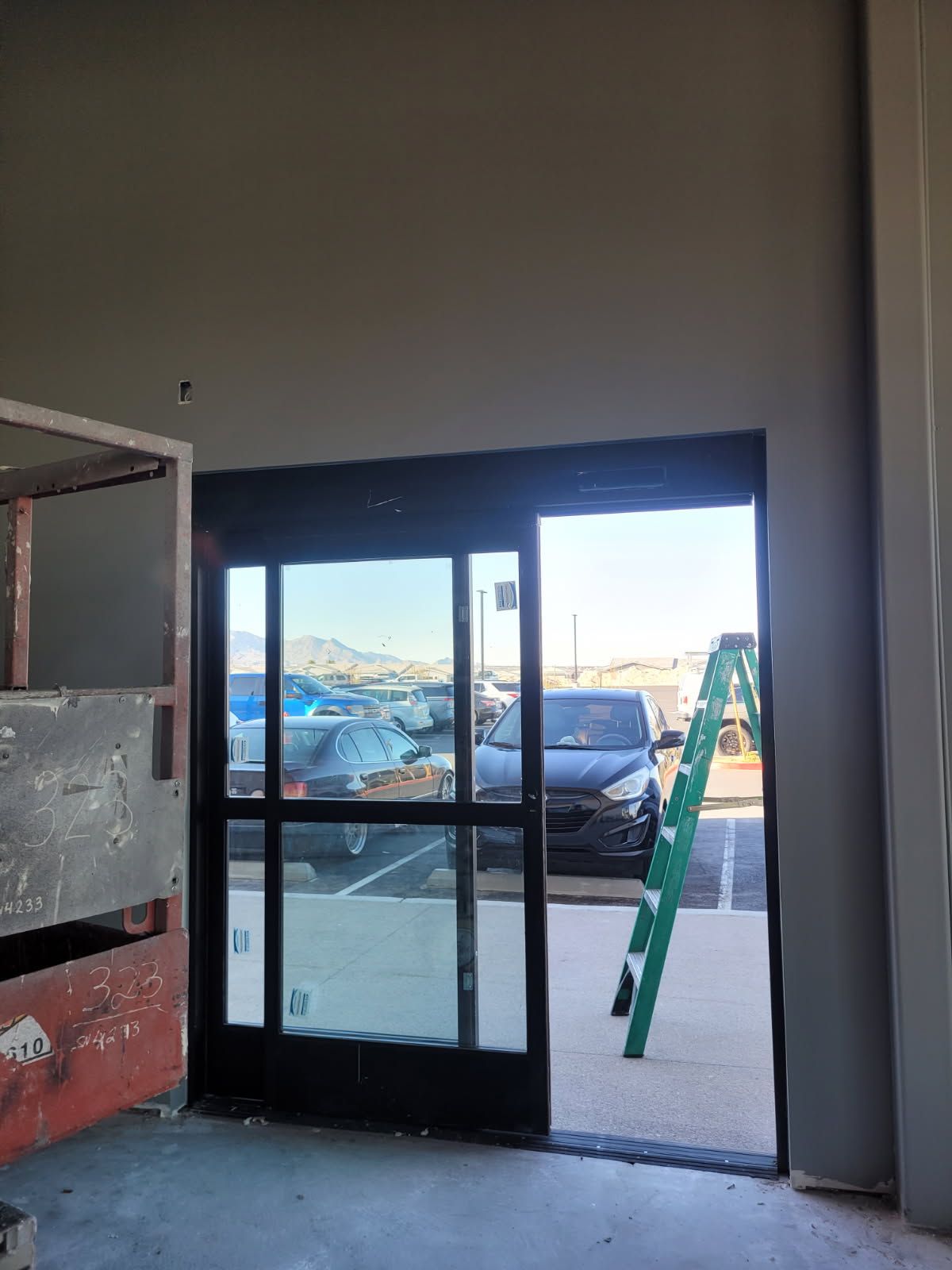 A ladder is sitting in front of a sliding glass door.