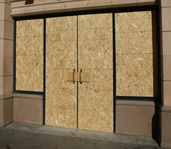 A building that has been boarded up with plywood