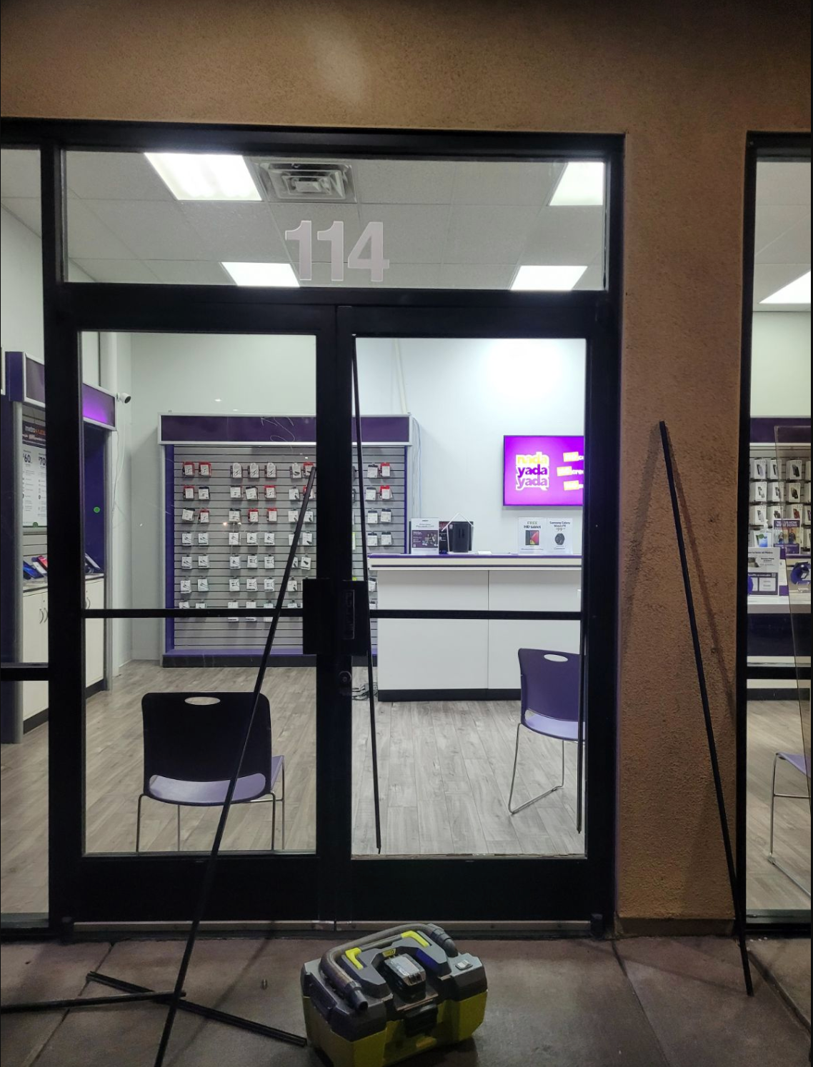 The front door of a store with the number 114 on it