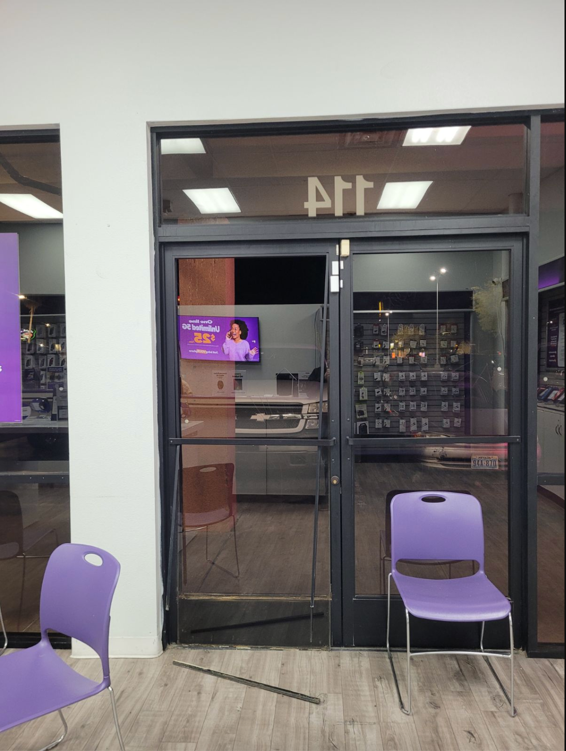 A purple chair sits in front of a glass door